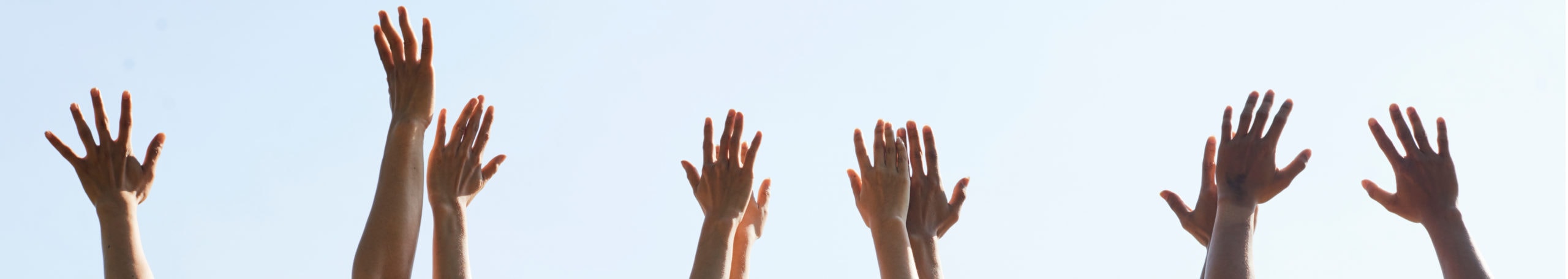 Group Of People With Hands Up In The Air
