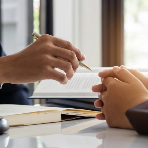 Two Men With Hands On A Desk