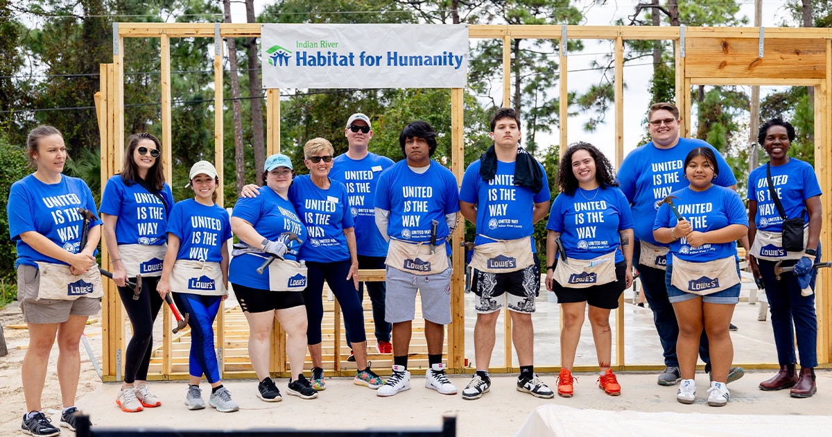 Day of caring volunteers at habitat for humanity